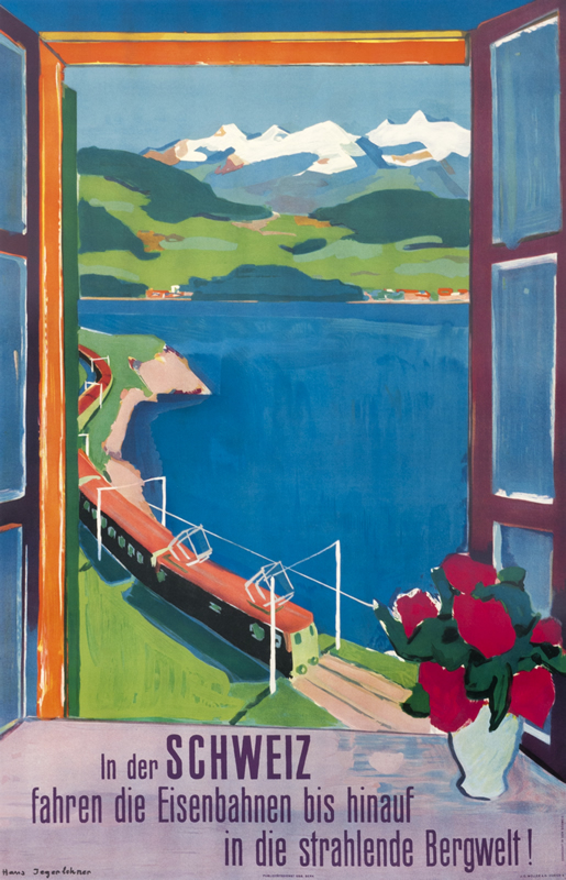 View of train passing by mountainside lake through window; blue, green, orange, red