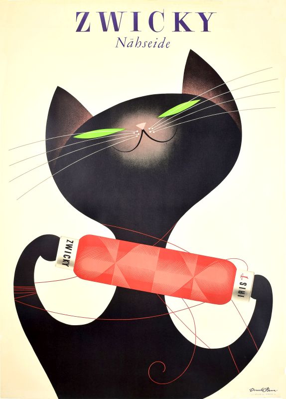 Cat plays with spool of yarn; white, black, red
