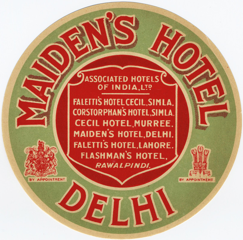Crest in the middle with name of hotel surrounding it; green, white, red