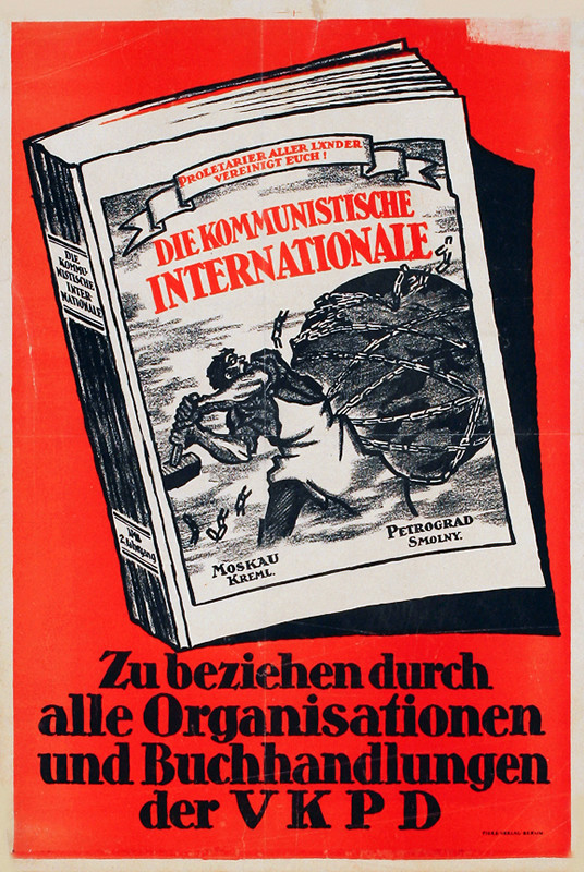 Book with man hammering chains around world on cover; black, red